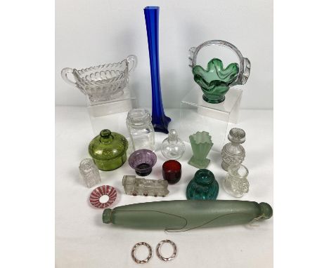 A collection of antique and vintage glassware. To include a rolling pin, novelty egg cups, long stemmed  blue vase, lidded tr