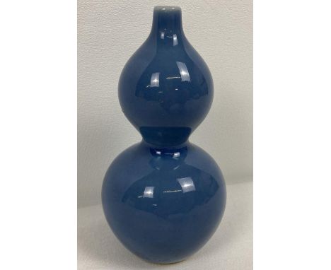 A small Chinese ceramic bottle gourd shaped bud vase with blue glaze. Signature marks to underside. Approx. 11.5cm tall.  