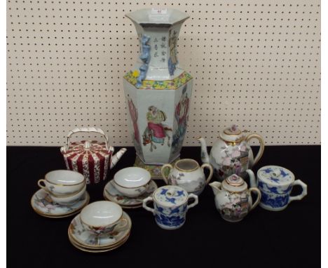 Chinese famille rose hexagonal porcelain vase, with applied Buddhist dog handles and figural painted panels between yellow fl