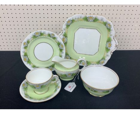 Attractive Aynsley Bone China tea service, decorated with waterlillies on a pale green ground, pattern B3717