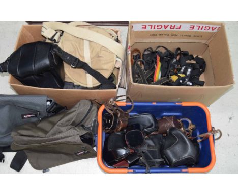 A collection of vintage and contemporary camera cases, mostly leather, together with assorted branded camera straps and furth