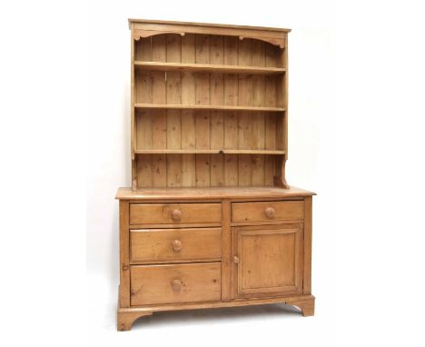 Stripped pine dresser, the open shelf back over four drawers and a panelled cupboard upon bracket feet, 50" wide, 19" deep, 7