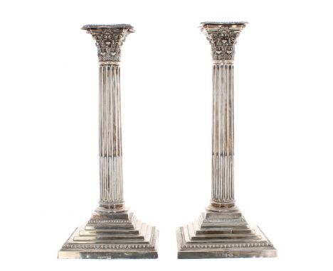 *matched* Pair of late Victorian silver Corinthian column candlesticks, with cast capitals over cylindrical fluted columns up