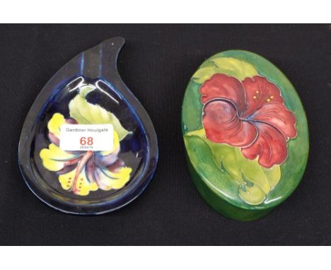 Moorcroft pottery Lily pattern ashtray on a deep blue ground, 6" wide; together with a Lily pattern oval lidded box, 5.5" wid
