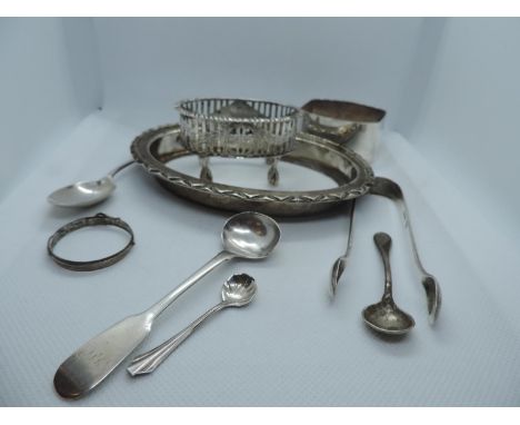 A Collection of Silver Items, to include a Napkin Ring, Teaspoon, Sugar Nips, Condiment Spoon, Salt Cellar Base, and other Ha