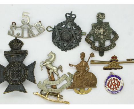Five cap badges: 20th London Regiment officers cap badge, Royal Sussex Regiment, British Army Jewish Chaplains badge, Royal N