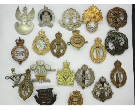 Twenty mixed British regimental cap badges, including Royal Armoured Corps, Army Remount Service, Army Catering Corps, Army L