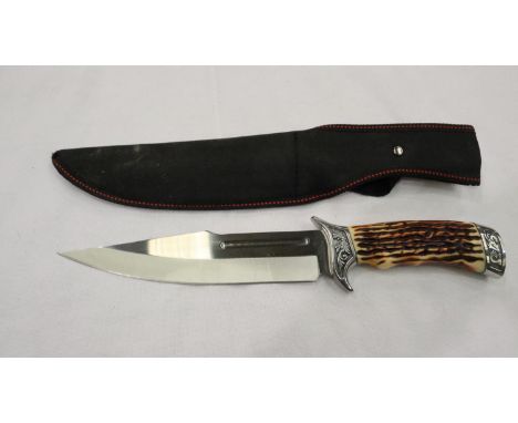 A modern hunting knife with faux antler grip and canvas sheath. P&amp;P Group 2 (£18+VAT for the first lot and £3+VAT for sub