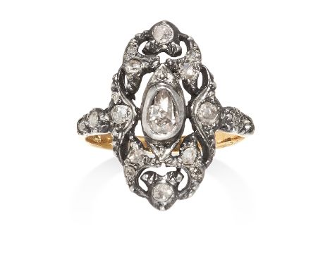 AN ANTIQUE DIAMOND RING in yellow gold and silver set with a central rose cut diamond within open scrollwork body jewelled wi