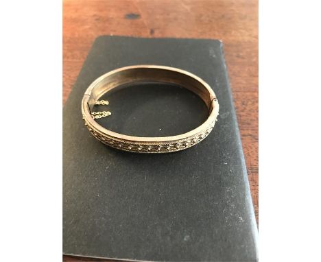 A 9ct gold hinged bangle 10.7gms