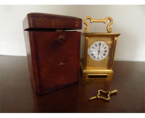 Good brass carriage clock with original shagreen case and key. Winds ticks and chimes, face with hairline cracks