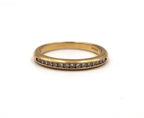 An 18ct yellow gold half eternity ring, size J/K, approx 2.5 grams