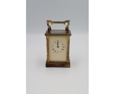 A brass cased carriage clock, ACG to back, with key, Roman numerals to dial, running in saleroom