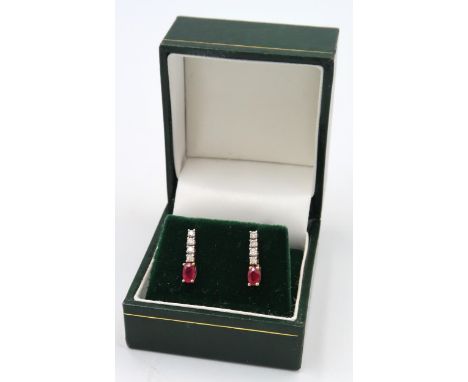 A pair of ruby and diamond drop earrings, Stamped 9K. 0.10ct. Weight 1.44 grams