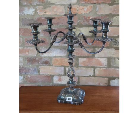 A silver plated five sconce candelabra, with finial to centre sconce decorated with foliate design