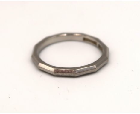 A platinum ring with a 12 sided edge to outer rim, approx 3.5 grams, size K/L