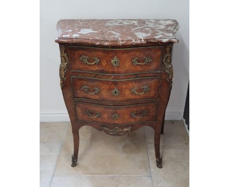 A French Louis XV style, marquetry inlaid commode chest of three long drawers raised on sabre supports ormulu mounted with ma