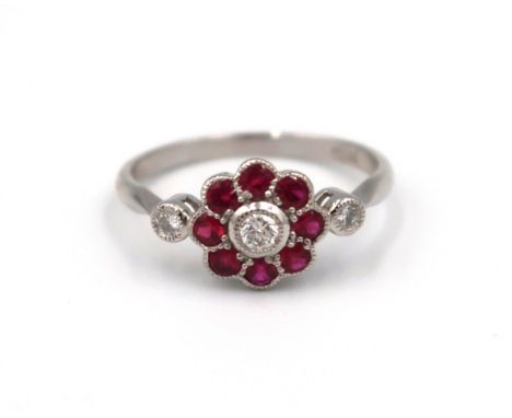A good quality platinum ruby and diamond ring retailed by Luke Stockley of London - head size approx 14mm x 9mm - ring size a