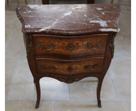 A French Louis XV style, marquetry inlaid commode chest of two long drawers raised on sabre supports, ormulu mounted with mar