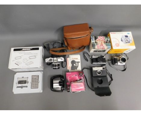 A selection of camera equipment including Canon FX 35mm film camera, Kodak Instamatic 33, Minolta Highmatic &amp; Bose Ipod k