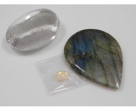 A faceted crystal, possibly rock crystal twinned with a opal &amp; a labradorite tear shaped stone