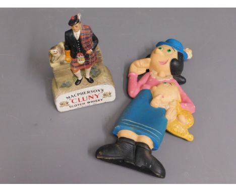 A Macpherson Cluny Scotch Whisky advertising model twinned with an Olive Oil hot water bottle