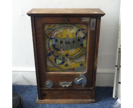 An early 20th century&nbsp;Allwin style penny slot Machine, housed in oak case&nbsp;with internal metal ball track, central i