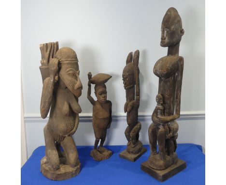 Tribal art: a carved wood&nbsp;Dogon maternity figure,&nbsp;of a mother holding her infant child on her lap seated on a stool