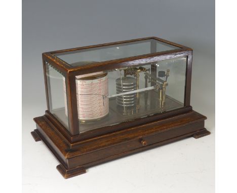 An Edwardian oak cased Barograph, the framed applied with beveled glass, above a skirted base and shaped bracket feet, W 38 c