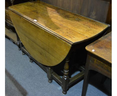 A joined oak gateleg table, oval top with two fall leaves, frieze drawer, baluster turned gate legs, the top 120cm x 152cm, h