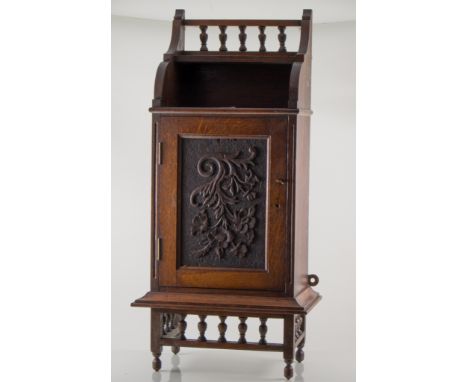 Two similar small oak cabinets with drawers, gallery and moulded panelled doors, a sarcophagus shaped rosewood twin compartme