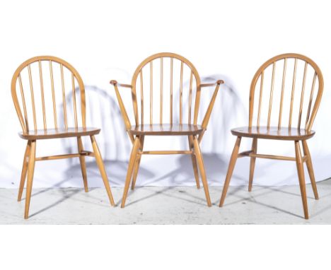 Set of six Ercol beech kitchen chairs, each with a hoop-back, turned spindles, boarded seat, turned legs, comprising two elbo