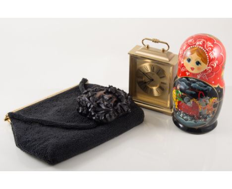 Swiza 8 carriage type clock, 145cm; a nest of Russian Dolls (Matryoshka dolls); crocodile skin handbag; and a beadwork handba