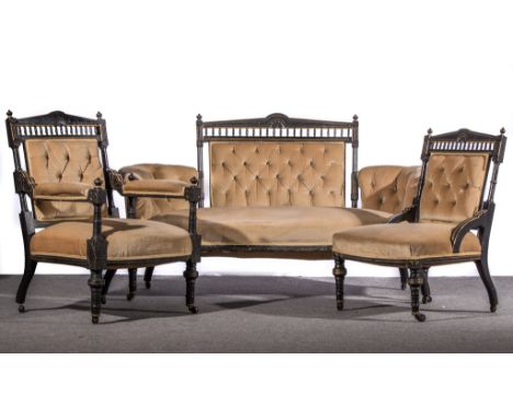 An English Aesthetic movement ebonised salon suite, circa 1870, comprising sofa, gentleman's arm chair and similar lady's arm