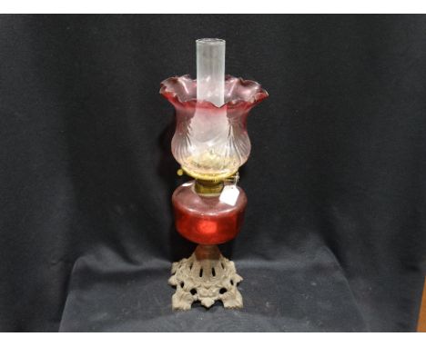      An Antique Metal Based Oil Lamp With Cranberry Tinted Reservoir & Shade         