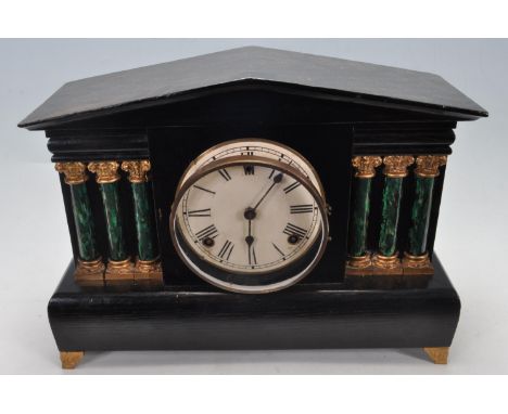 A vintage 20th century mantel clock of architectural form having a pediment top with six green Corinthian columns raised on a