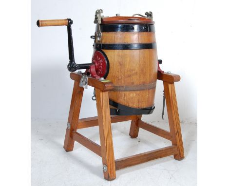 A vintage&nbsp;Waide &amp; Sons, Leeds, oak barrel butter churn and stand. the barrel having a cast iron turning handle with 