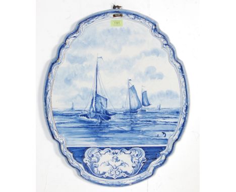 A 19th century Victorian blue and white Delft ceramic wall plaque. The large oval plaque having scrolled edges with raised ma