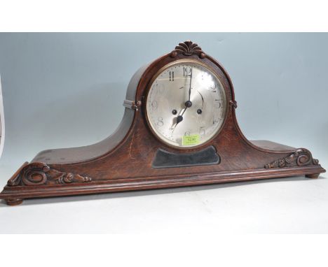 An 20th century Napoleons hat 8 day mantel clock having a silvered face with arabic numerals to the chapter ring set within a