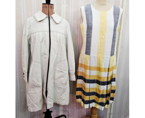 Cream linen coat with black saddle stitching, zip front, pintucks, Peter Pan collar, double vent at the back, a linen drop-wa