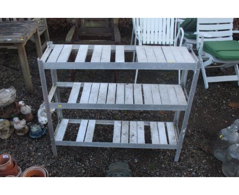 A lightweight aluminium three tier potting shelf