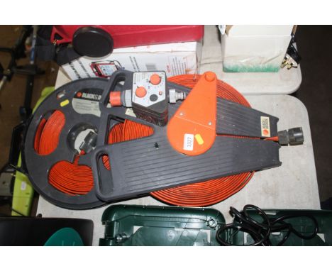 A Black & Decker 20m roll up hose reel; a Black & Decker wind up hose reel and a Gardena electric water timer