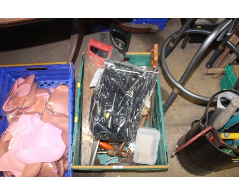 A plastic crate containing a quantity of tools to include hand saws and braces; oil can etc