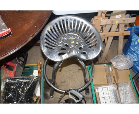 A heavy tractor stool, named to W. M. Doyle & Co Ltd in grey metallic finish