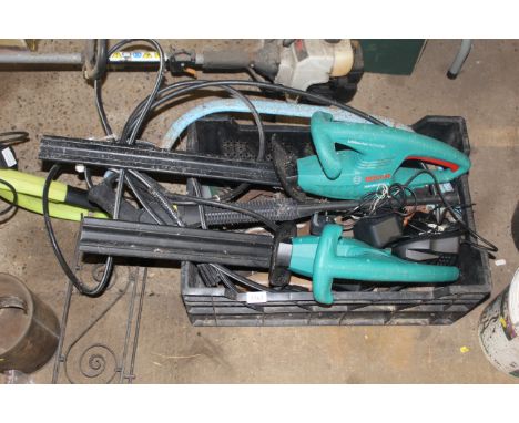 A crate containing various garden tools to include two electric Bosh hedge trimmers with two batteries and two chargers; a pr