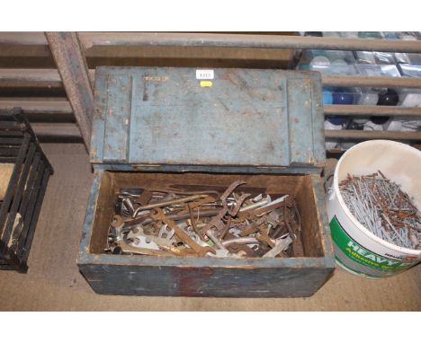 A blue painted wooden tool box with hinged lid and quantity of tools to include spanners etc.