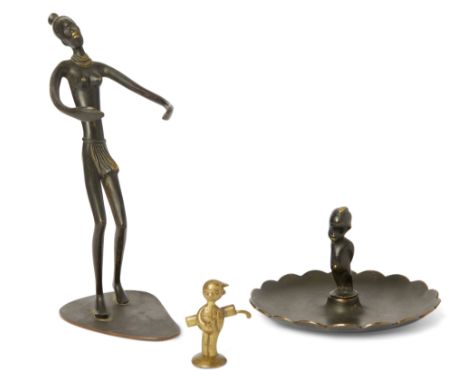 Hagenauer Two figural sculptures comprising a golf caddy and dish surmount with infant, together with a Richard Rohac African