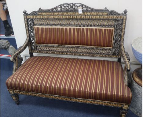 A late 19th/early 20th century ebony and porcupine quill sofa by H Don Carolis and Sons, Colombo W.122cm