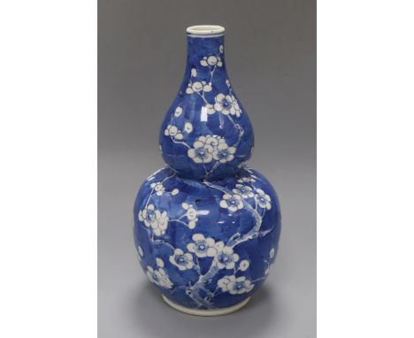 A 19th century Chinese blue and white double gourd vase, Kangxi mark height 33cm