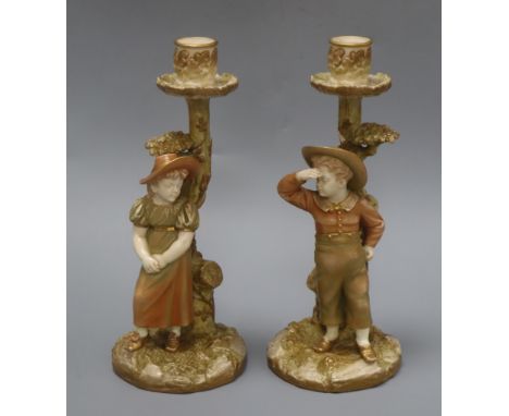 A pair of Royal Worcester Hadley candlesticks height 25.5cm
